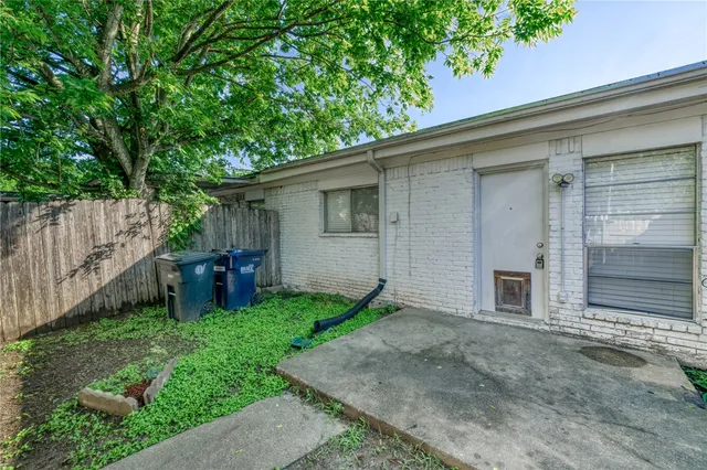 a backyard of a house with table and chairs