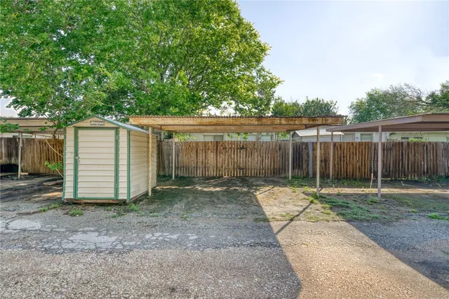 a backyard with wooden fence and trees