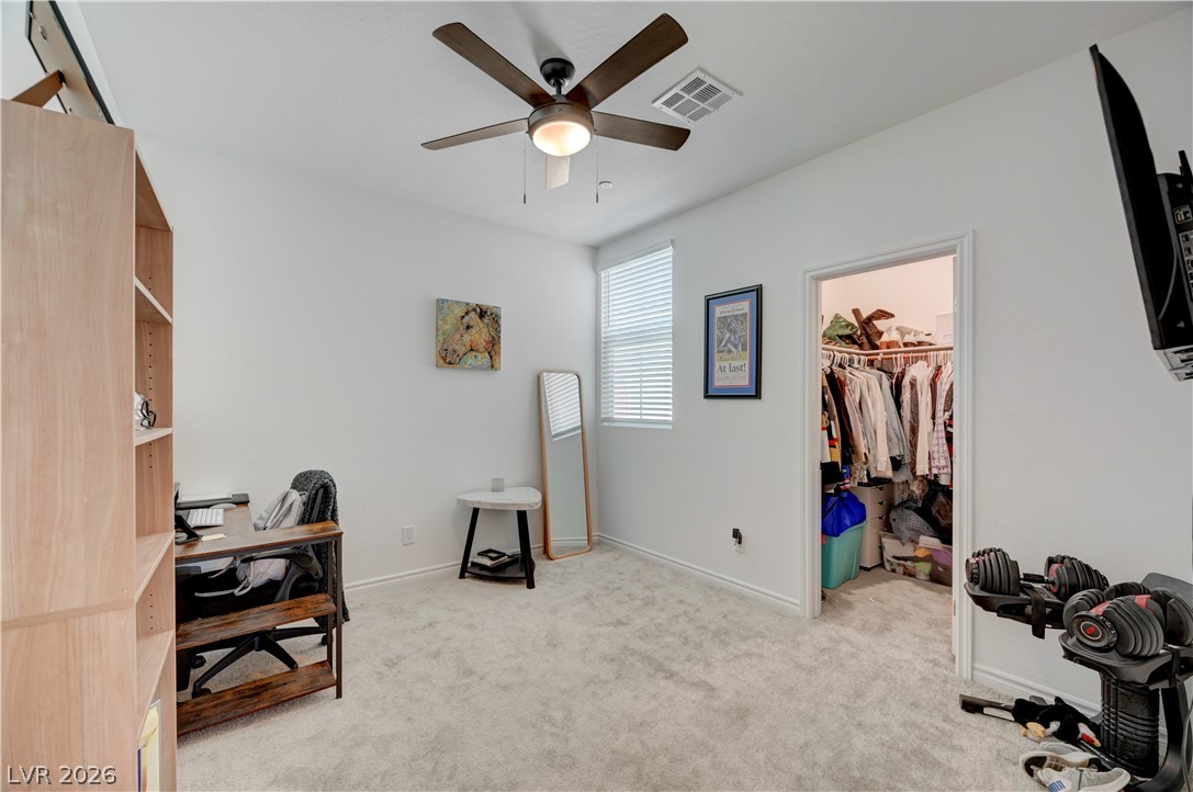 7204 North Decatur Boulevard, Unit 3 North Las Vegas, NV 89084 - Photo 26 of 48 Well-lit room featuring a practical walk-in closet and comfortable carpet flooring.