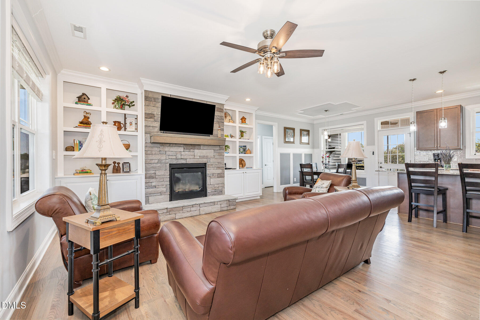 17 Kiowa Court Willow Spring, NC 27592 - Photo 5 of 27 a living room with furniture a flat screen tv and a fireplace
