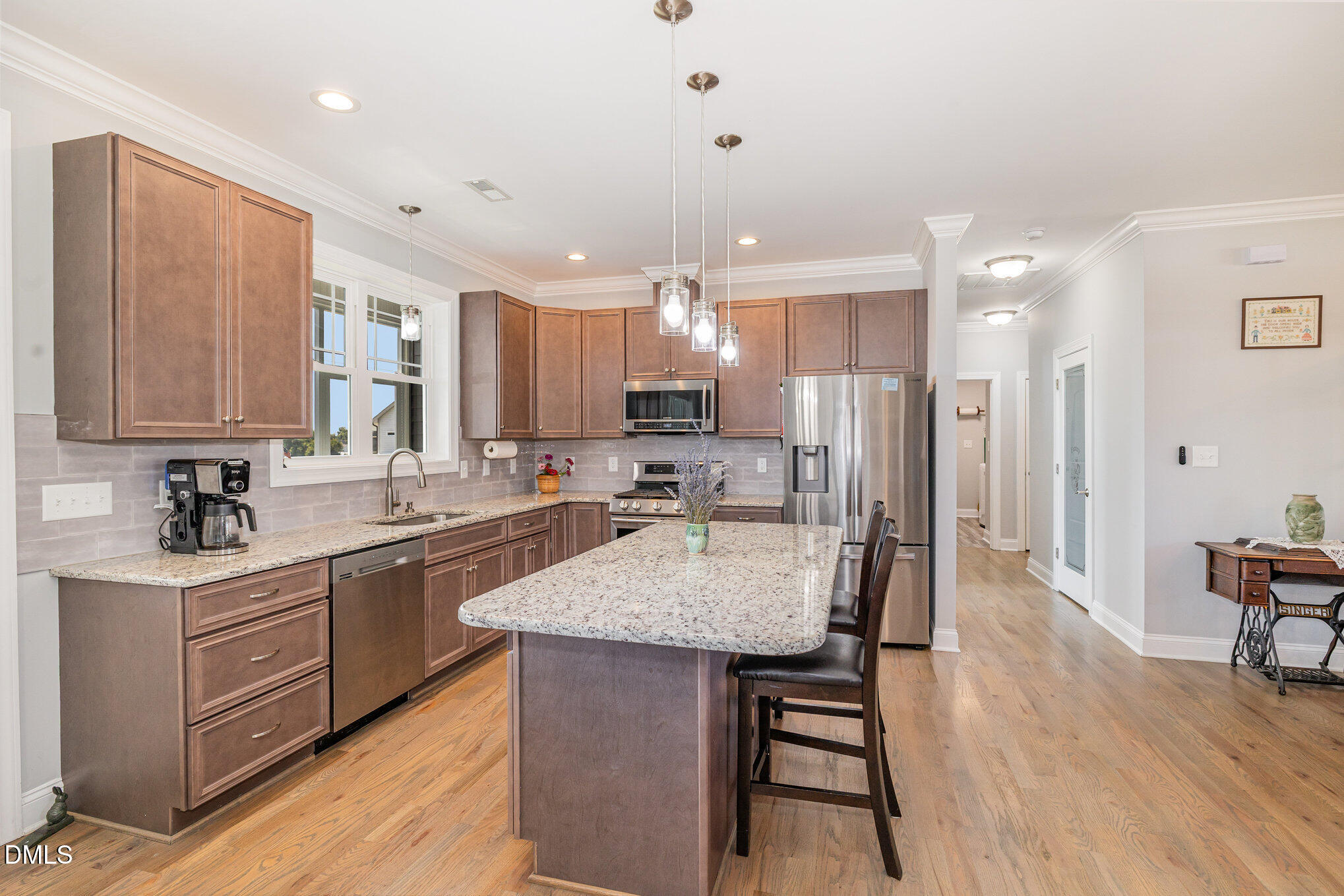 17 Kiowa Court Willow Spring, NC 27592 - Photo 9 of 27 a kitchen with stainless steel appliances granite countertop a stove top oven a sink dishwasher a dining table and chairs with wooden floor