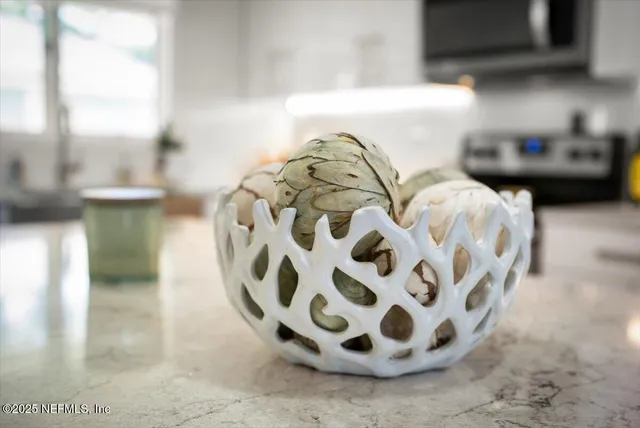 a kitchen with white cabinets and appliances