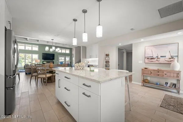 a view of a dining room with furniture and a chandelier