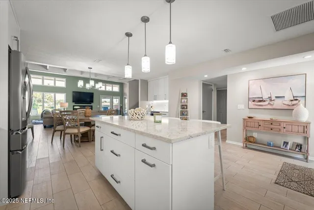 a view of a dining room with furniture and a chandelier