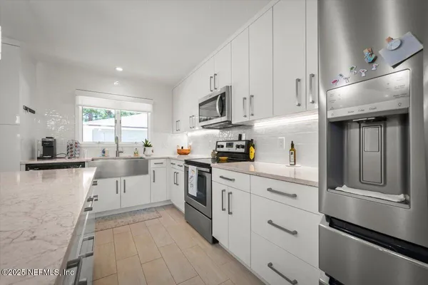 a dining room with a wooden table and chairs