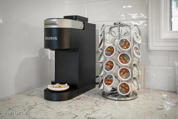 a living room with furniture a flat screen tv and a large window