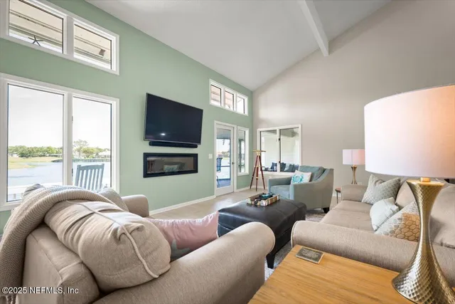 a living room with furniture a clock and a large window
