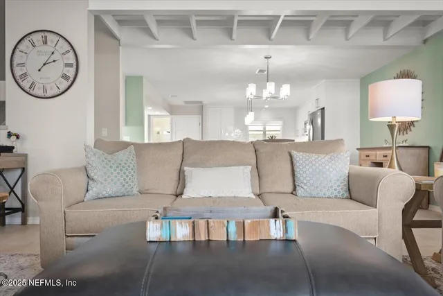 a living room with furniture and large windows
