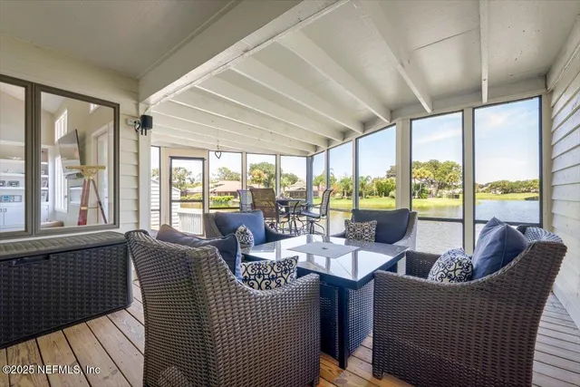 a bedroom with two bed and a lamp on dresser