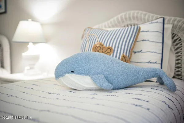 a bedroom with furniture and a large window