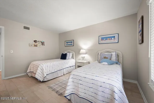 a bedroom with a bed and painting on the wall