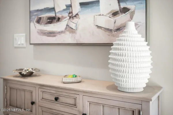 a kitchen with cabinets and chairs