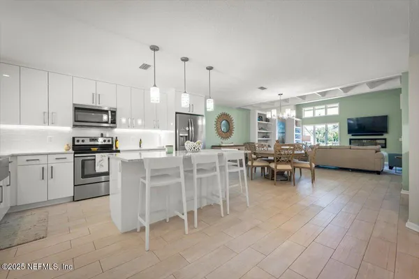 a kitchen with cabinets and chairs