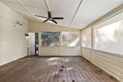 a view of outdoor space with wooden floor and windows
