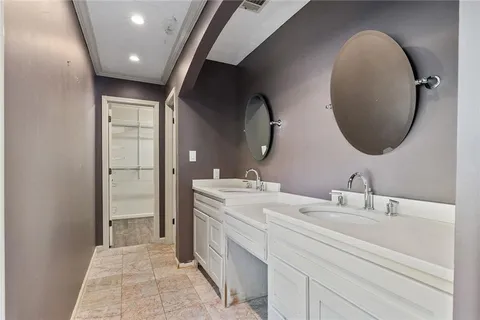 a bathroom with a double vanity sink and a mirror