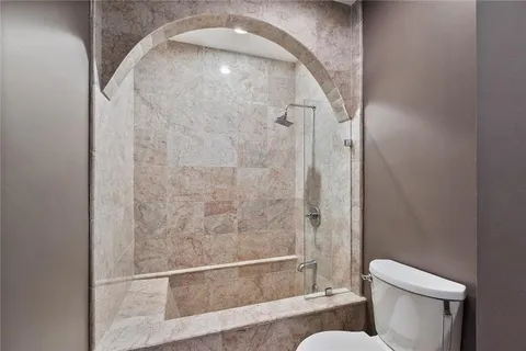a bathroom with a toilet and a shower