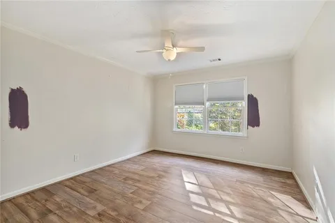wooden floor in an empty room with a window