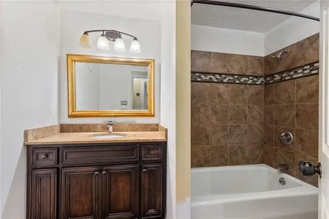 a bathroom with a bathtub and a mirror