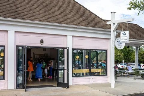 a view of a chairs and window in the backyard