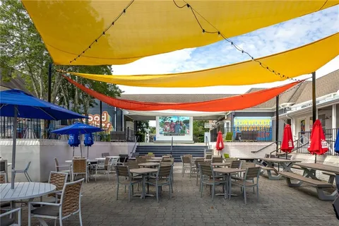 a view of a patio with a dining table and chairs under an umbrella