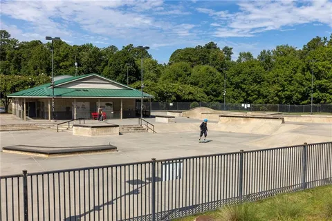 a green field with some trees in the background