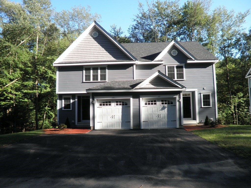 113 Dudley Road, Unit 113 Berlin, MA 01503 - Photo 1 of 17 a front view of a house with a yard