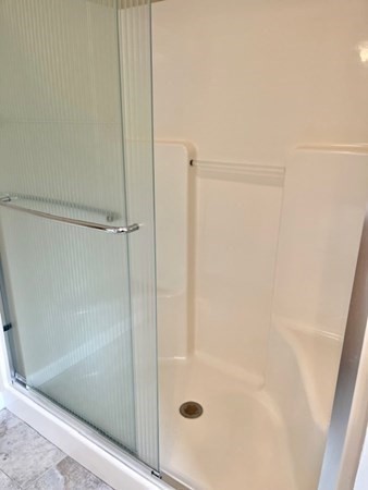 113 Dudley Road, Unit 113 Berlin, MA 01503 - Photo 13 of 17 a bathroom with a glass shower door