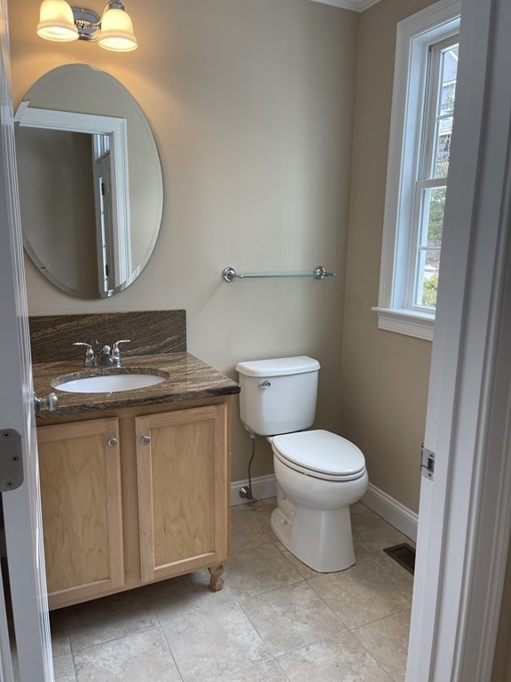 113 Dudley Road, Unit 113 Berlin, MA 01503 - Photo 4 of 17 a bathroom with a toilet sink and mirror