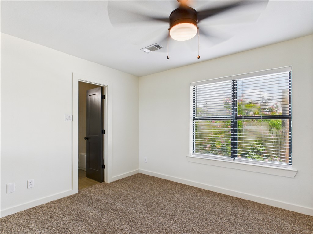 309 Mobile Avenue, Unit 5 Bryan, TX 77801 - Photo 13 of 17 an empty room with a window and a ceiling fan
