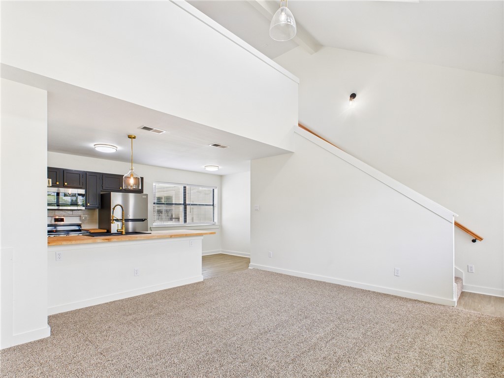 309 Mobile Avenue, Unit 5 Bryan, TX 77801 - Photo 5 of 17 a view of a kitchen with kitchen island and stainless steel appliances