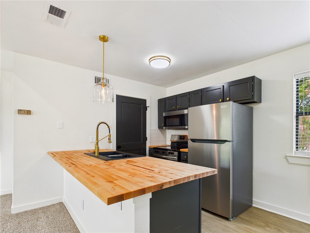 309 Mobile Avenue, Unit 5 Bryan, TX 77801 - Photo 6 of 17 a kitchen with a refrigerator a sink and a refrigerator