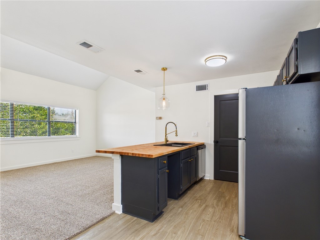 309 Mobile Avenue, Unit 5 Bryan, TX 77801 - Photo 10 of 17 a kitchen with stainless steel appliances granite countertop a sink stove and refrigerator