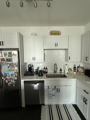 a kitchen with a sink a stove and cabinets
