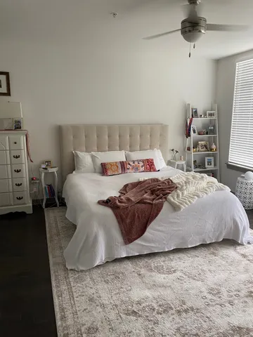 a bedroom with a bed and a dresser
