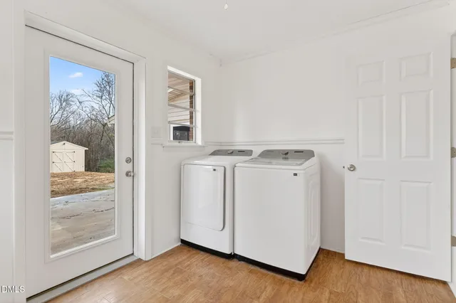 a kitchen with granite countertop a stove a sink and white cabinets with wooden floor