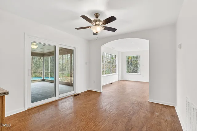 a view of a ceiling fan and hardwood floor