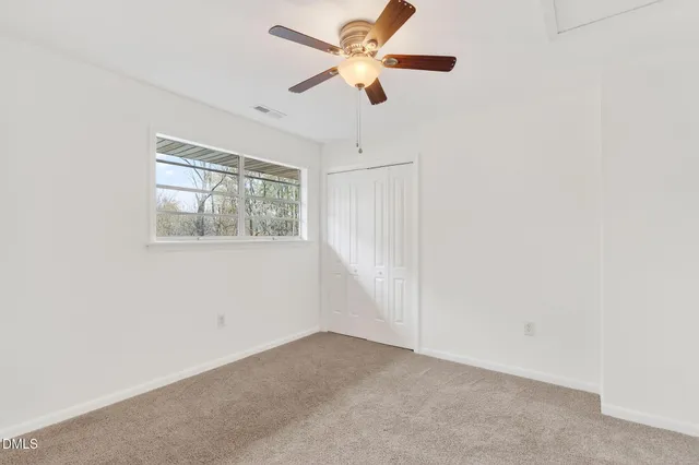 a front view of a house with a yard table and chairs