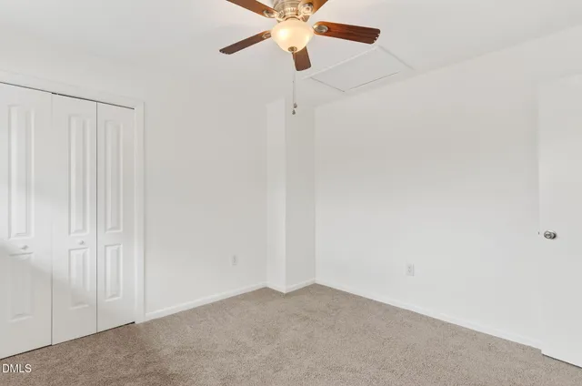 a front view of a house with a yard covered in snow