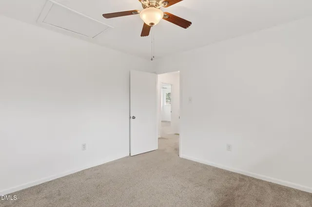 a backyard of a house with a large tree