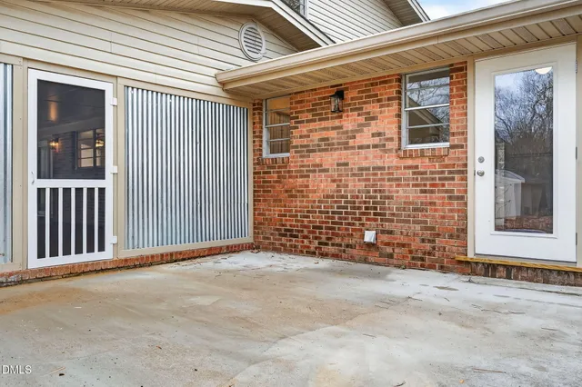 a aerial view of a house with swimming pool and large trees