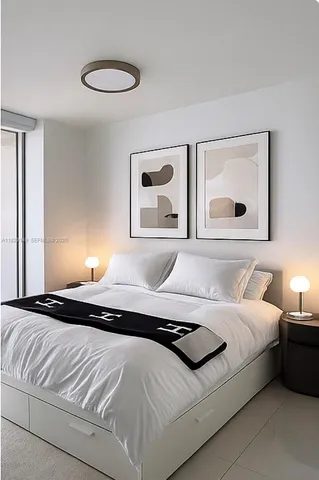 a bedroom with a bed and lamp