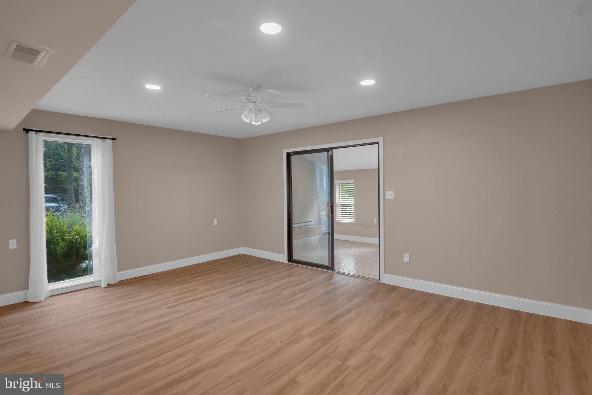 110 Hopewell Road Marlton, NJ 08053 - Photo 41 of 54 a view of an empty room with wooden floor and a window
