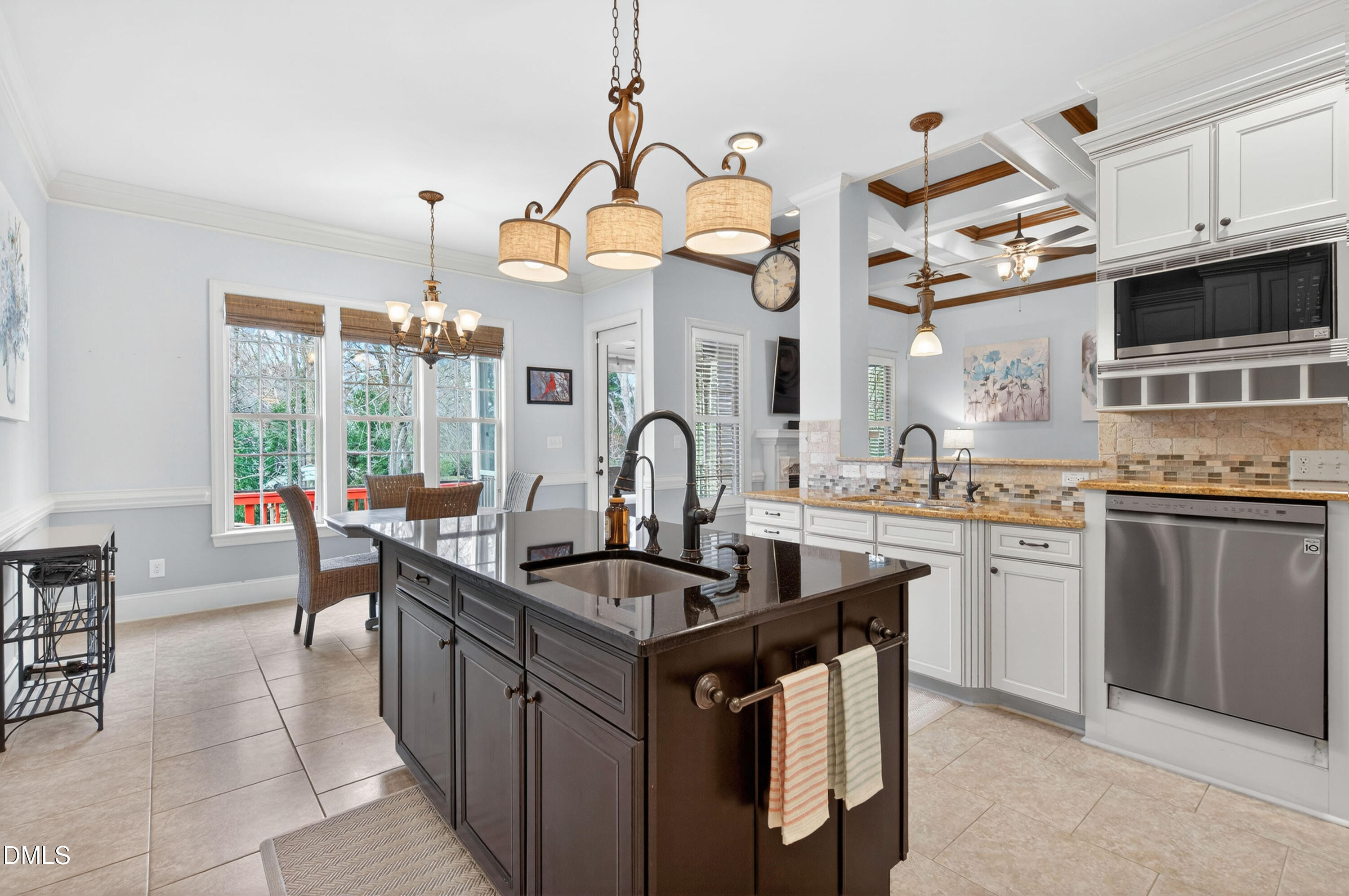 691 Hawthorne Place Creedmoor, NC 27522 - Photo 20 of 84 a kitchen with granite countertop a sink and cabinets