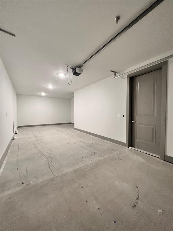4020 McEwen Road, Unit 9123 Farmers Branch, TX 75244 - Photo 10 of 20 Garage featuring baseboards and a garage door opener