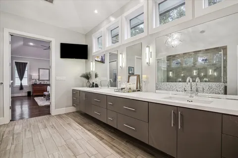 a spacious bathroom with a double vanity sink and a mirror