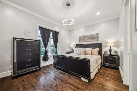 a spacious bedroom with a bed and a dresser