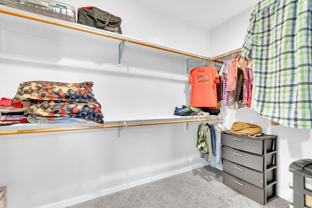 a bedroom with a large bed window and a ceiling fan