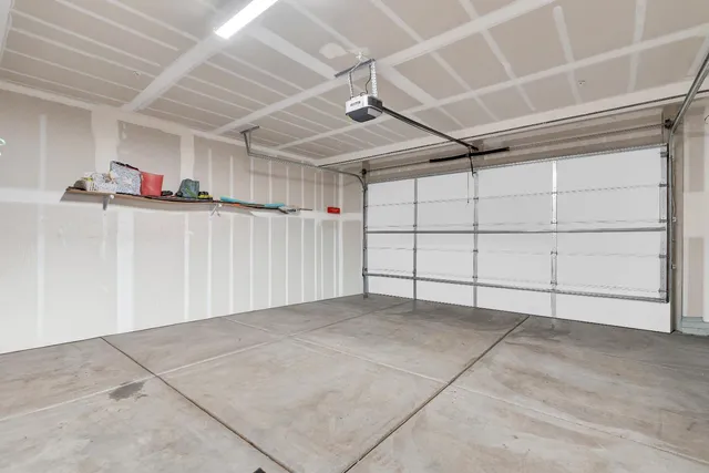 a view of a house with potted plants and a garage
