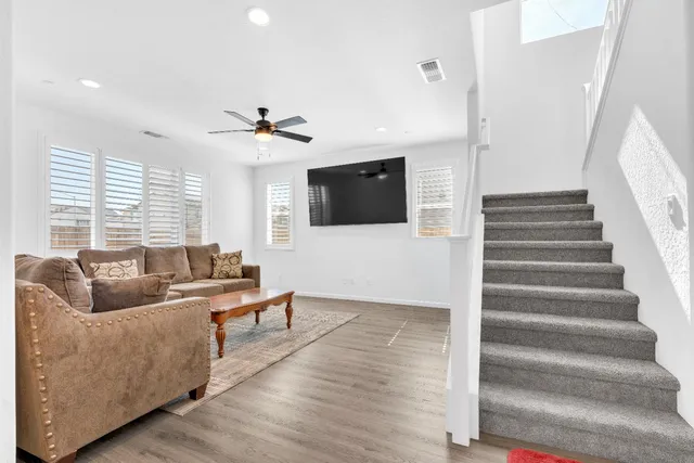 a living room with furniture and a kitchen view