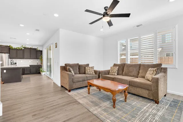 a large kitchen with stainless steel appliances sink a microwave and cabinets